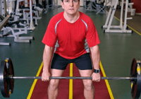 Man lifting barbell in gym