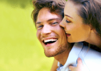 Woman playfully hugging smiling man