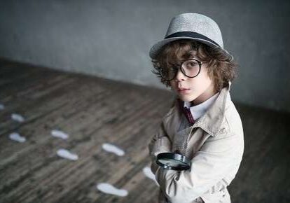 Child detective with magnifying glass