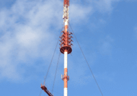 Tall communication tower with clouds