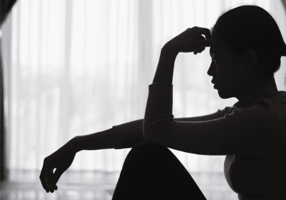 Contemplative silhouette against a bright window