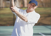 Man in white shirt playing tennis
