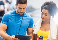 Gym trainer consulting with a client