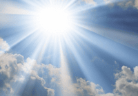 Sun rays breaking through cloudy sky.