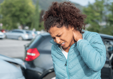 Injured woman standing by damaged cars