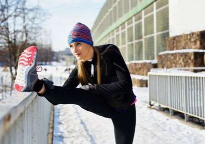 Woman stretching outdoors in winter
