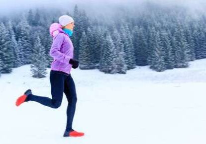 Athlete jogging through snow-covered forest