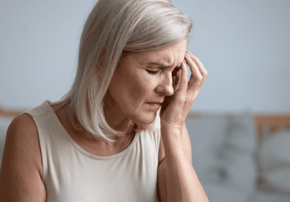 Senior woman holding her head