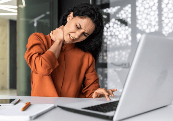 Person massaging neck while working