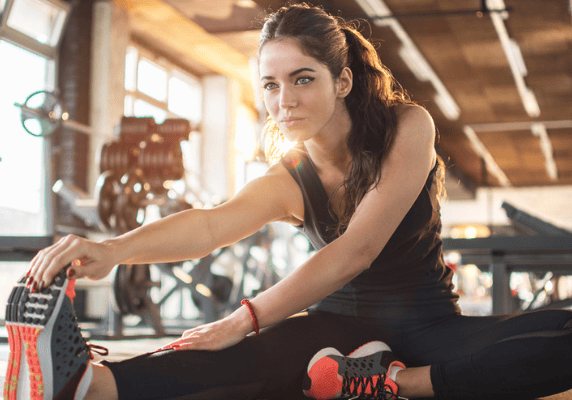 Woman stretching on gym floor