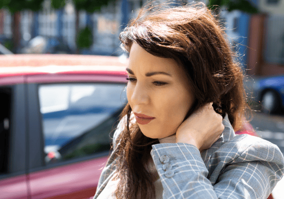 Woman standing by a red car
