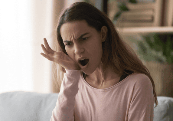 Woman yawning on a couch
