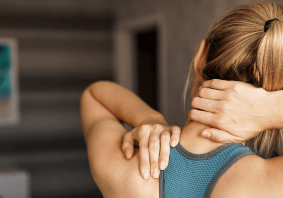Woman massaging her neck and shoulder