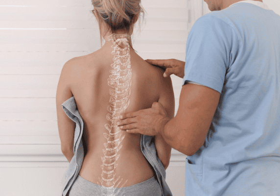Back examination with spine illustration overlay