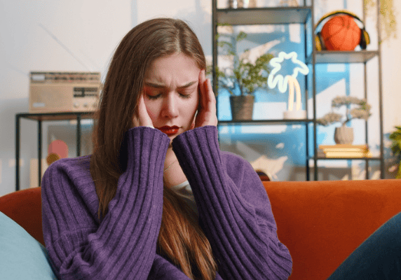 Young woman holding head in frustration